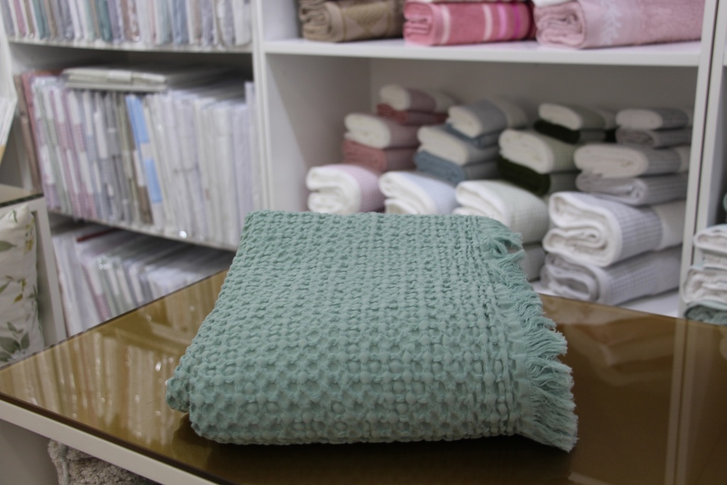 Manta decorativa verde com padrão de favo de mel