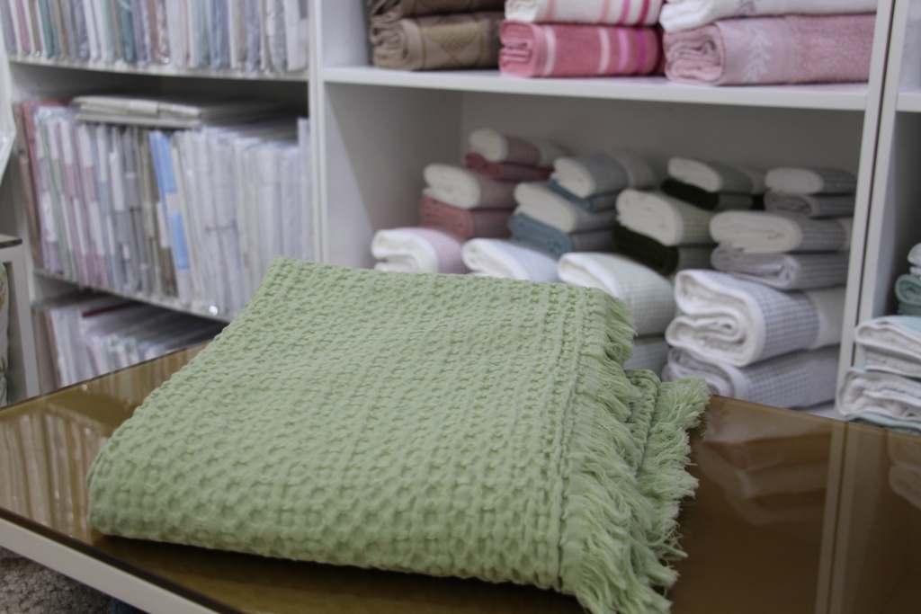 Manta decorativa verde com padrão de favo de mel